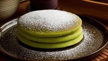 A stack of soft and airy Japanese matcha souffle pancakes dusted with powdered sugar, served on a plate. photo