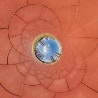 A circular view of a city skyline from inside a circular tunnel photo