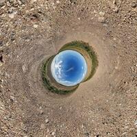 A view of a blue sky from inside a circular hole photo