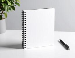 Minimalist Empty Spiral Notebook with Pen on Clean Desk photo