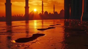 Golden sunset over mosque with wet reflective floor photo