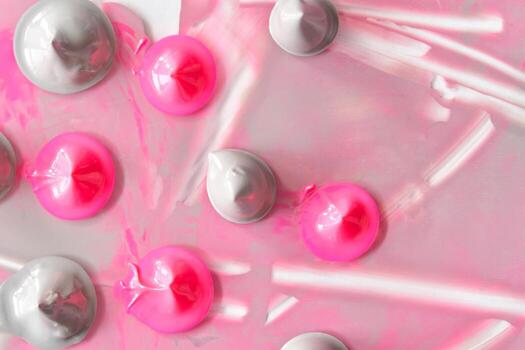 Abstract pink and gray paint blobs on canvas creating a unique textured art design. photo