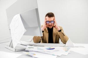 A sad businessman in an office, facing problems, stress, and mistakes with documents. The concept is to capture the atmosphere of deadlines and challenges in the workplace photo