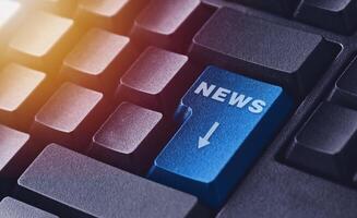 The news button on a black keyboard. Computer keyboard button photo