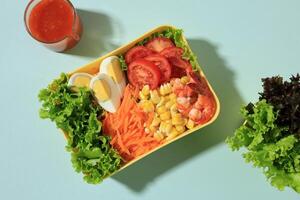Fresh Summer Salad with Shrimp, Corn, Boiled Egg, Tomato, Carrot, and Lettuce. photo