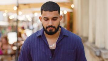 Aggressive angry indian man upset sad dissatisfied mad looking at camera in urban city street video