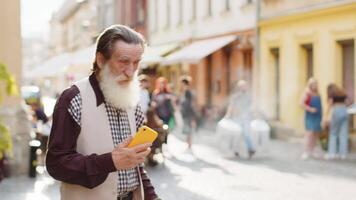 Tourist elderly man grandfather using looking smartphone search a way on map in mobile navigator app video