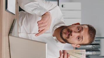 Young business man showing money dollar cash gives to you wages salary, satisfied with good work video