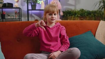 Upset child kid girl showing thumbs down dislike game fail disapproval dissatisfied feedback at home video
