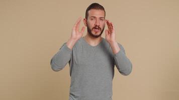 Annoyed irritated handsome man covering ears gesturing No avoiding advice ignoring noise loud voices video