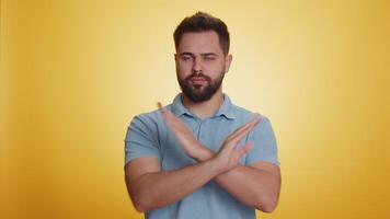 Young man say No hold palm folded crossed hands in stop gesture warning of finish prohibited access video