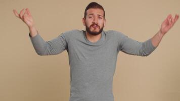Puzzled clueless uncertain man raising hands in helpless, embarrassed confused by difficult question video