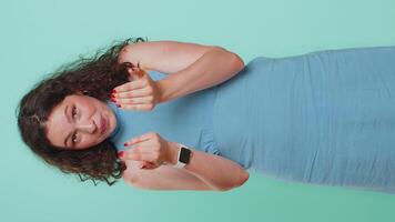 Woman showing a little bit gesture with sceptic smile showing minimum sign measuring small size video
