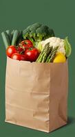 A brown paper bag filled with vegetables and fruits photo