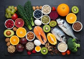 A variety of foods including fish, fruits, vegetables and nuts photo