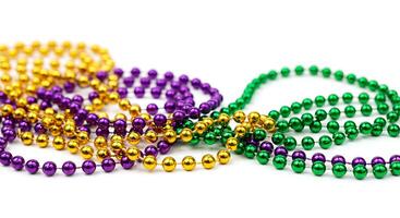 Mardi gras beads on a white background photo