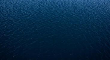 An aerial view of the ocean with a boat in the middle photo