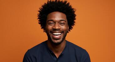 A smiling man with an afro on an orange background photo