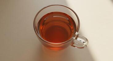 A glass cup of tea on a table photo