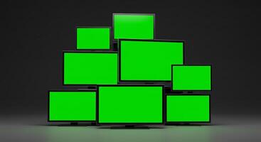 A stack of green screen monitors on a black background photo