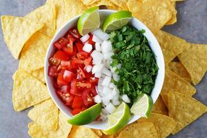 Fresh Homemade Salsa with Tomatoes, Onions, Cilantro, Lime Wedges, photo