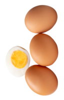 A stack of raw brown chicken eggs and cooked or boiled chicken egg with egg yolk in half isolated in file format png