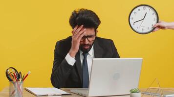 Indian business man with anxiety checking time on clock running late to work being in delay deadline video
