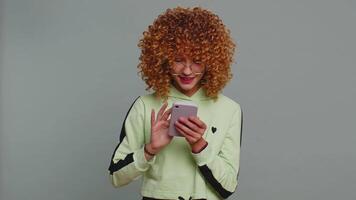 Child girl kid use mobile smartphone browsing say Wow yes found out great win good news celebrate video
