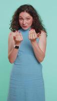 Woman showing a little bit gesture with sceptic smile showing minimum sign measuring small size video