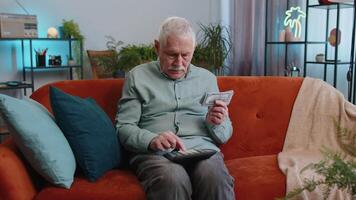 Rich grandfather old man counting money cash and use calculator, calculate domestic income earnings video