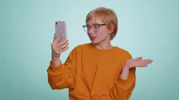 Young woman traveler blogger taking selfie on smartphone communicating call online stream video