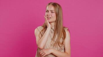 Young woman touching cheek, closing eyes with expression of terrible suffer from painful toothache video