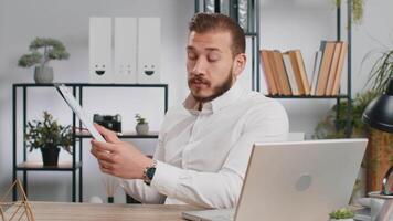 Business man making online presentation call, demonstrates graphic analytics looking at camera video