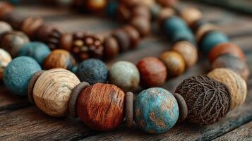Colorful wooden beads arranged on a rustic wooden surface create a vibrant display of craftsmanship and creativity photo