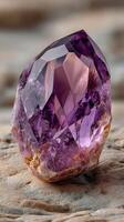 Natural amethyst crystal on stone surface showcasing its vibrant purple hues and intricate facets photo