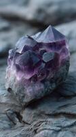 Amethyst crystal formation on textured rock surface in natural setting under soft lighting photo