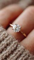 Elegant solitaire ring captured in soft natural light on a cozy knitted fabric background photo