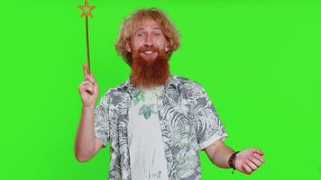 Magician witch young man gesturing with magic wand making wish come true, casting magician spell video