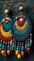 Colorful handmade earrings showcase intricate beadwork and vibrant patterns on rustic wooden background photo