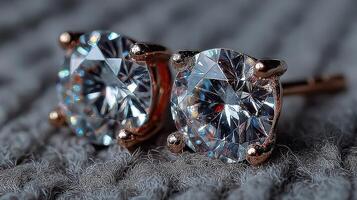 Sparkling diamond stud earrings displayed on textured fabric in a close-up view highlighting their brilliance and elegance photo