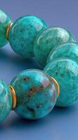 Vibrant turquoise beads on a striking blue background create a stunning visual display of craftsmanship and color photo