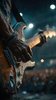 Guitarist performing passionately at a live concert in the evening with an energetic crowd in the background photo