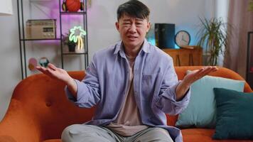 Asian man guy asking why, what reason of failure demonstrating disbelief irritation by troubles video