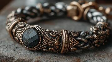 Intricate bracelet with detailed design rests on a textured surface in soft light showcasing craftsmanship and elegance photo