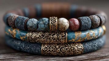 Handmade bracelets featuring natural stones and intricate metal designs displayed on a wooden surface photo