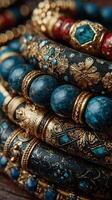 Stunning collection of ornate bracelets with intricate designs and bold colors arranged on a textured surface photo