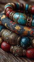 Handcrafted bracelets with intricate designs displayed on a wooden surface in a vibrant and artistic arrangement photo