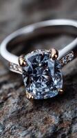 Stunning blue gemstone ring showcased with elegant band design on textured stone surface photo