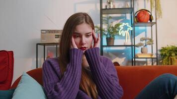 Displeased young woman rubbing temples to cure headache problem, suffering from migraine, stress video