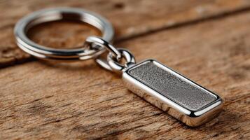 Keychain with rectangular metallic charm on wooden surface showcasing detailed craftsmanship and modern design elements photo
